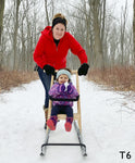 Mom and Toddler girl riding a ESLA T6 kicksled on the trails at River Bend Nature Center in Racine, Wisconsin