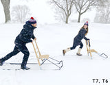 Man and woman couple riding ESLA T7 and T6 kicksleds through the snow in Saint Paul, MN